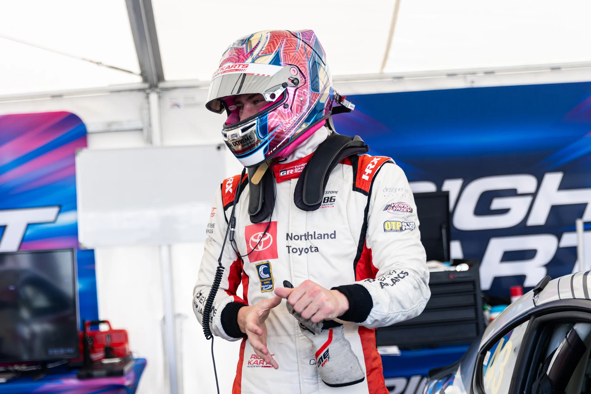 Cameron Hill in the paddock putting on racing gloves
