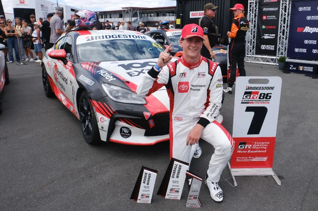 Cameron Hill with Overall Winner and Rookie Winner trophies after Hampton Downs